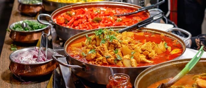 Pots full of curry dishes in a restaurant