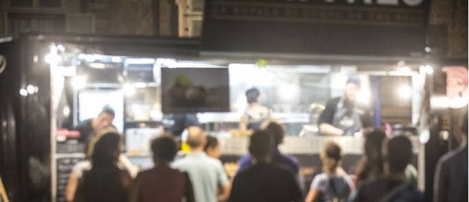 Crowd in queue at festival food truck stall