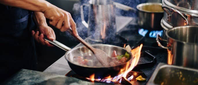 Chef making potentially fraudulent food in a restaurant kitchen