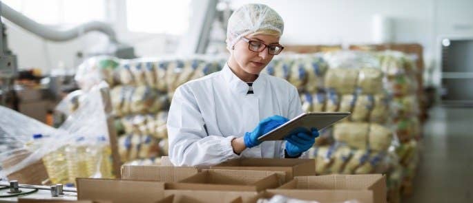 Woman in factory accepting a delivery with checklist