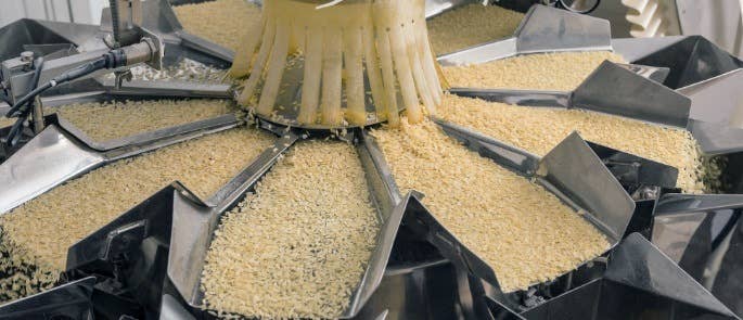 grain being fed into a large grain dispenser, showing the grain dispensing.