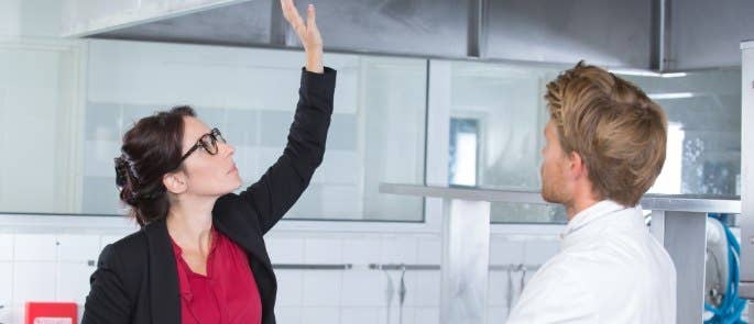 A responsible person inspecting kitchen equipment