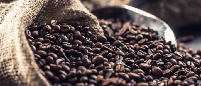 Loose coffee beans in a canvas bag