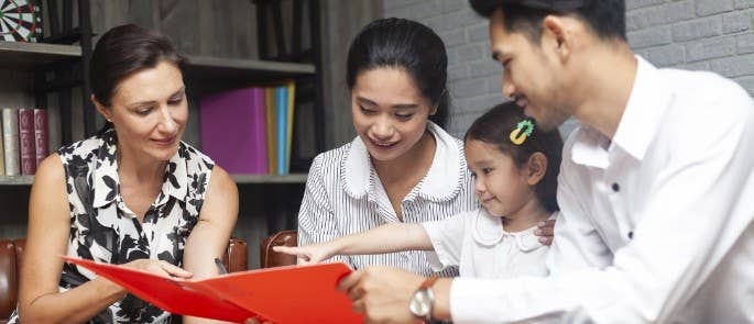 Professional, parents and child completing a Common Assessment Framework