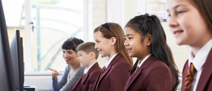 Alumnos de escuela que trabajan con computadoras