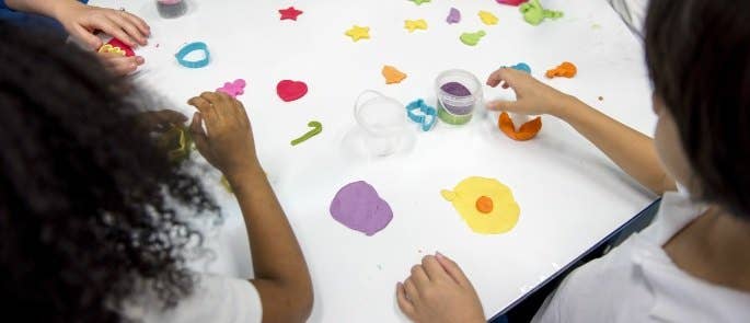 Group of students playing with dough at a breakfast club