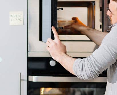 man reheating food safely