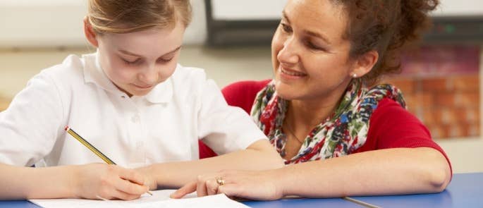 A teacher helping a student with their work