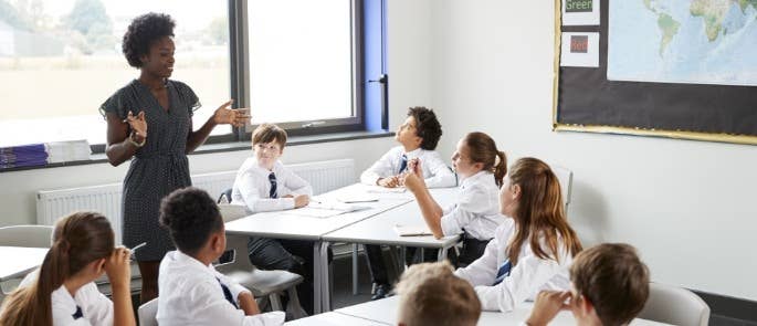 A teacher talking to children in a classroom