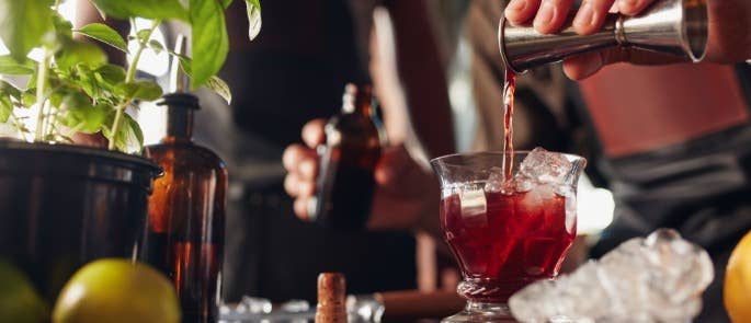 Bar worker pouring a drink