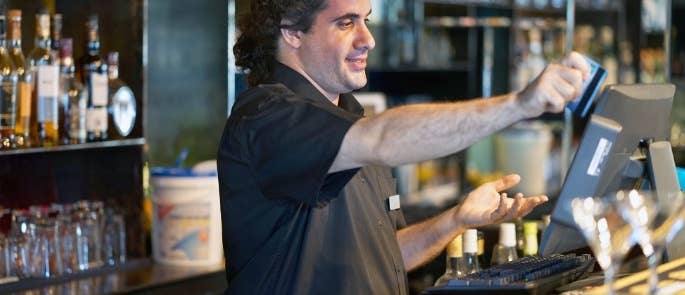 Bartender using a credit card