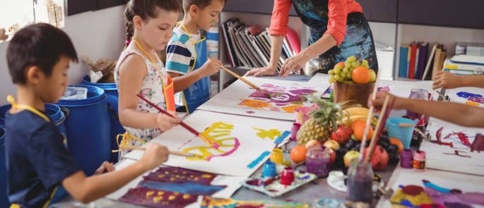 Children painting in a classroom