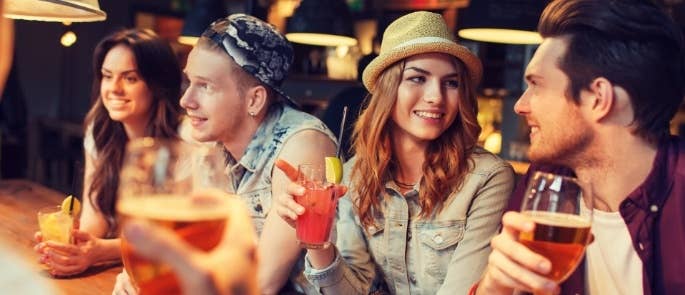 Customers at a bar drinking