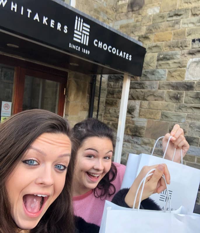 A & J leaving Whitakers Chocolates with goody bags