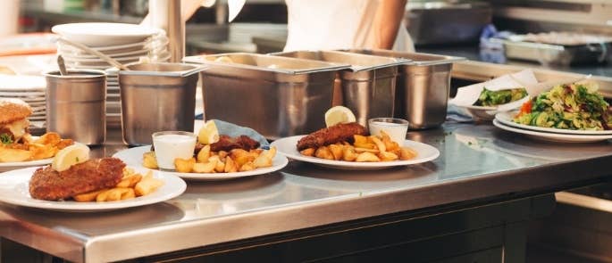 Plates of food ready to go in a kitchen restaurant