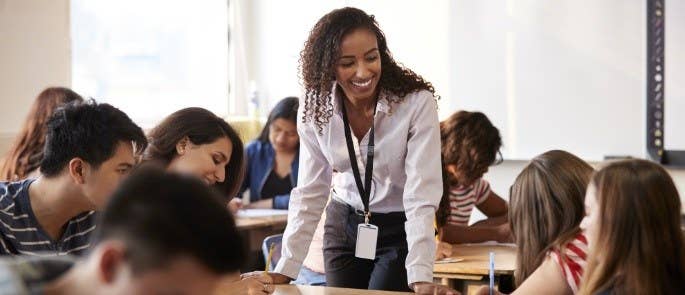 Female teacher in a classroom helping students