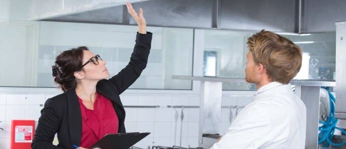 Business owner assesses the ventilation in a commercial kitchen for the risk assessment 