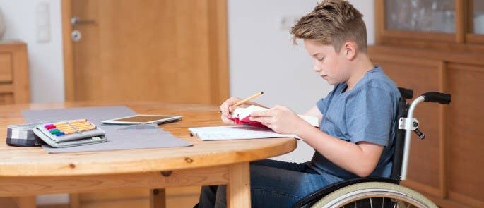 Student in a wheelchair completing their homework