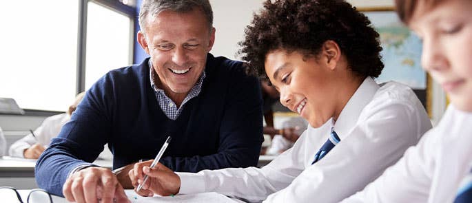 Teacher working with secondary school pupils