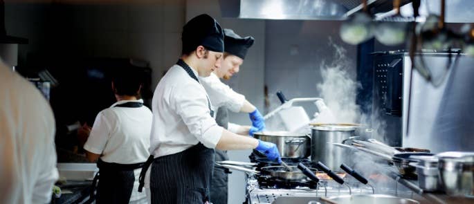 Two busy chefs working in kitchen