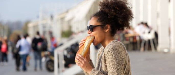 A woman eating a baguette