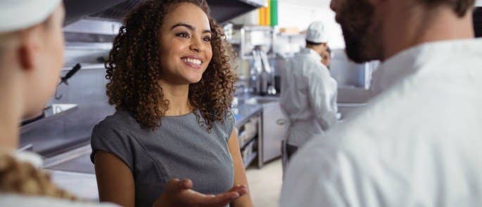 restaurant manager talks to staff