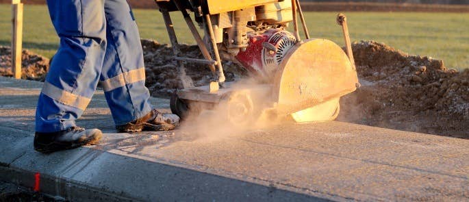 Worker cutting concrete