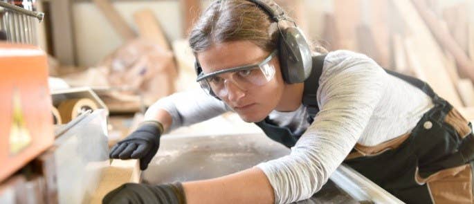 Woman in Design and Technology workroom working with wood