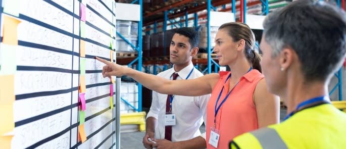 Warehouse workers discussing a project