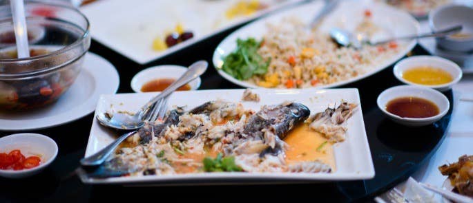 Plates of leftover food in a restaurant