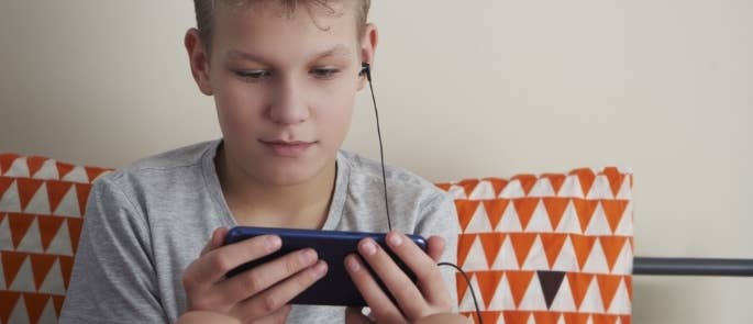 Young boy watching a video on his phone