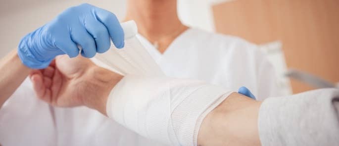 Healthcare worker putting a bandage on a patient