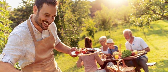 Man preparing a BBQ for his family