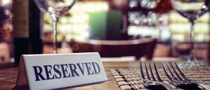 close up of a reserved sign on a set table in a restaurant.