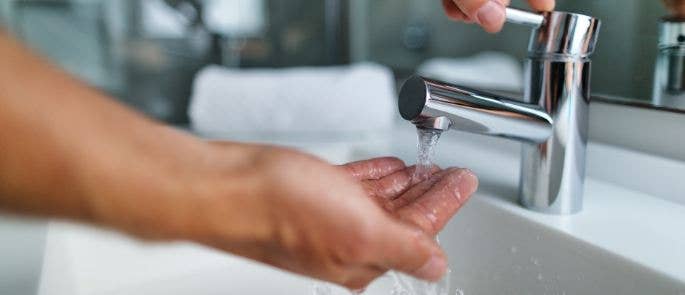 Hand-under-water-tap