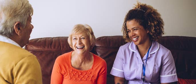 Carer enjoying a home visit with two patients