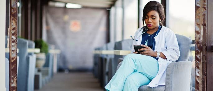 Nurse making a referral on her phone