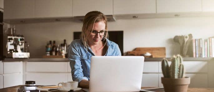 woman works from kitchen counter