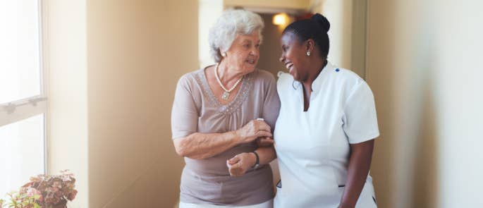 Carer and lady walking and laughing