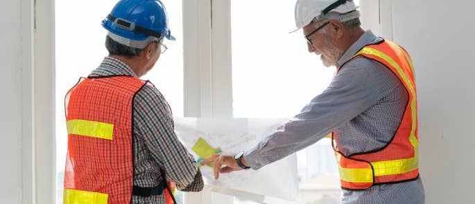 Construction workers wearing white and blue hard hats