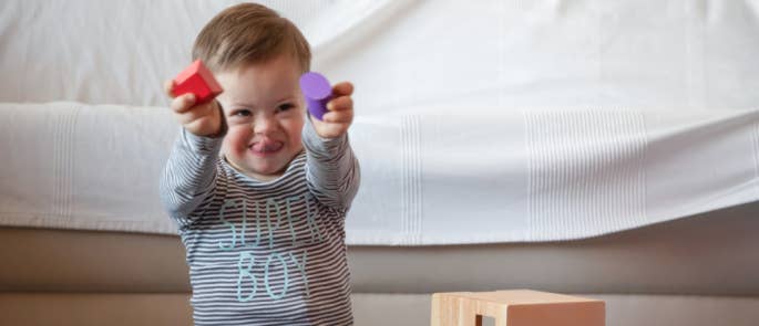 Young boy with down's syndrome playing in doctor's waiting room