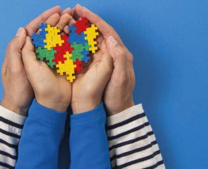 Person holding jigsaw pieces in school class