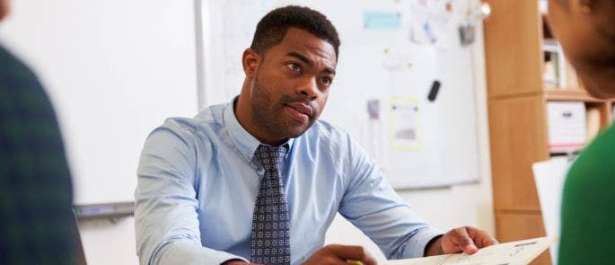 Male teacher talking to parents