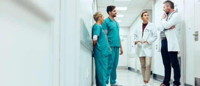 Group of doctors and nurses discussing changes within an organisation