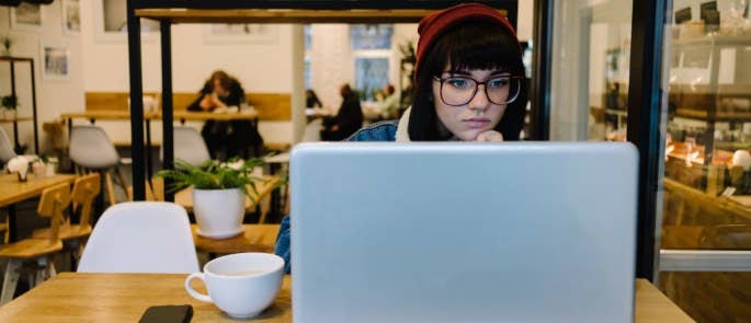 Girl completing online training in a cafe