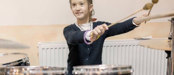 Young girl playing drums in therapy session