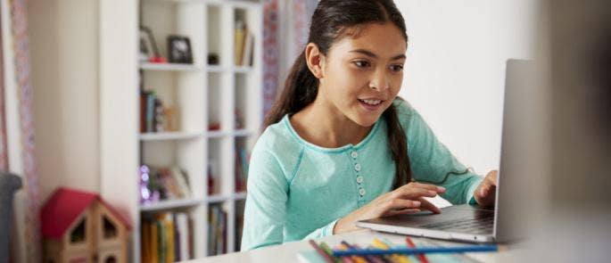 Young girl completing schoolwork at home