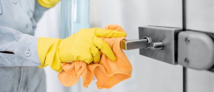 Cleaner wiping door handle with cloth