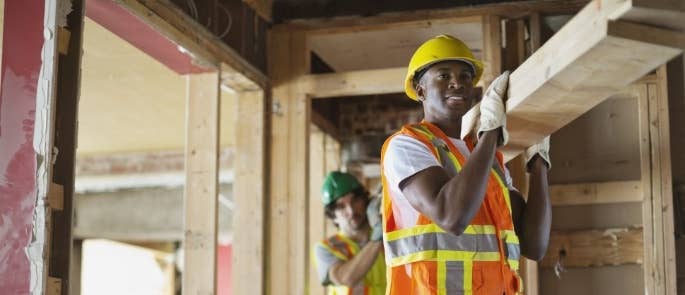 Construction workers carrying wood manual handling