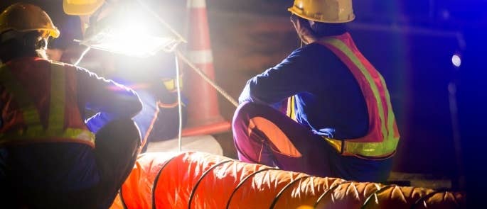 Construction workers with spotlight on site